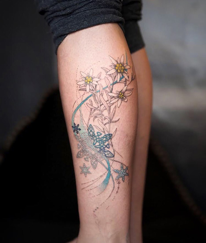 Floral and geometric calf tattoo design, showcasing unique artistry with delicate lines and soft colors.