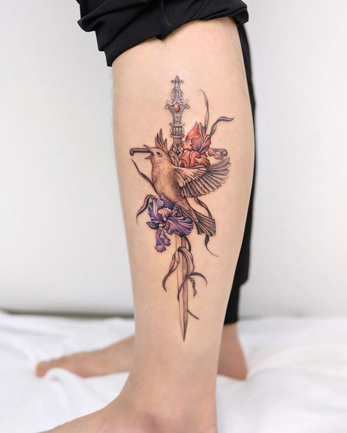 Bird and sword calf tattoo