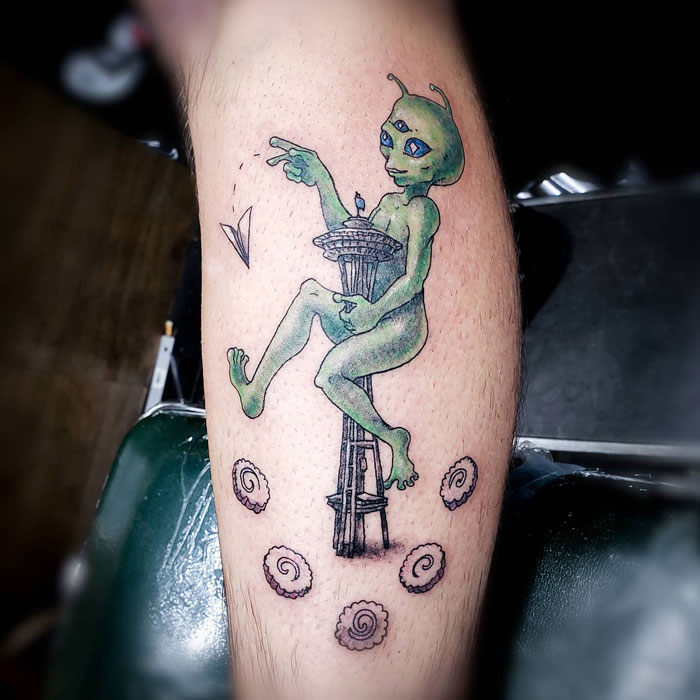 Alien calf tattoo