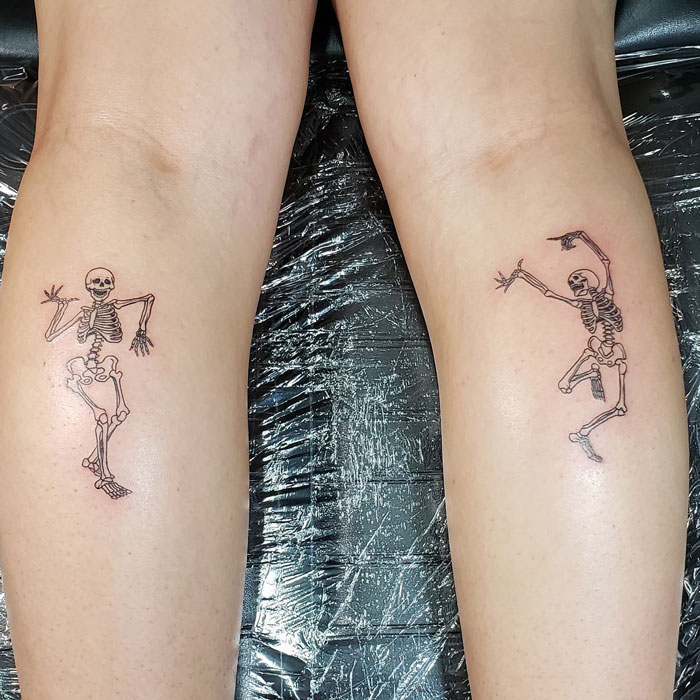 Dancing Skeletons calf tattoo