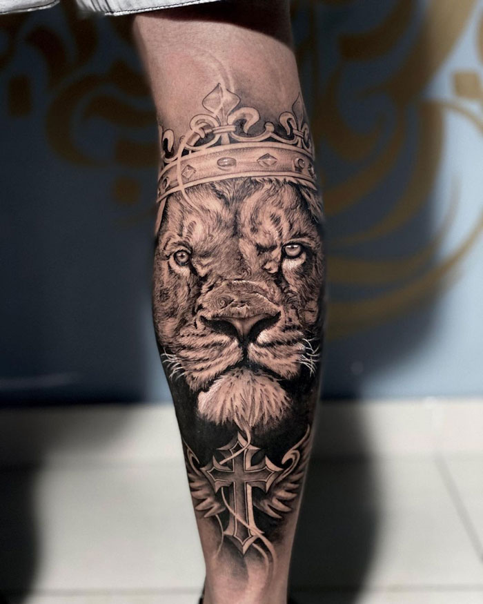Lion with crown calf tattoo