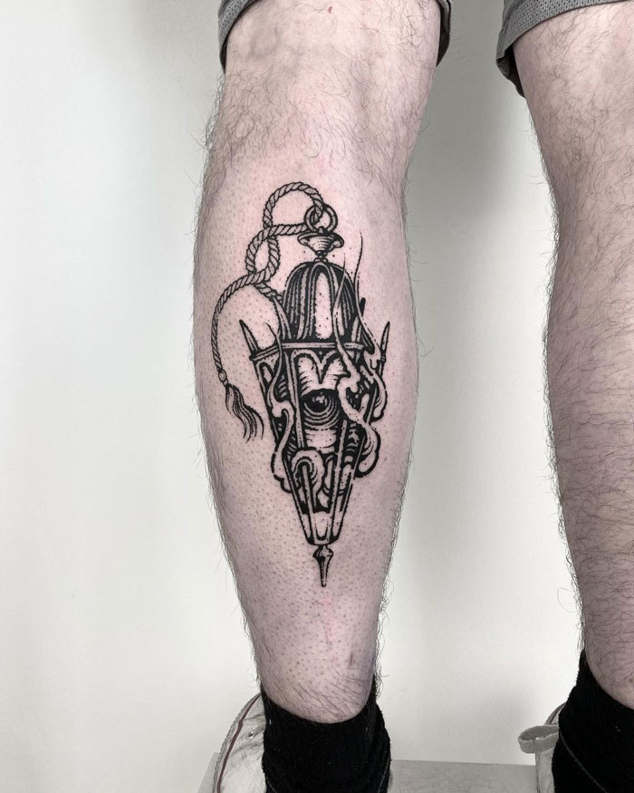 Black and white calf tattoo