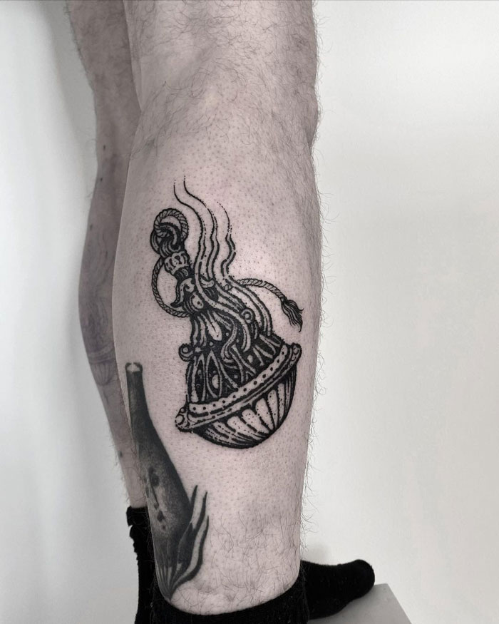 Black and white calf tattoo