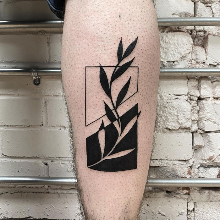Minimalist line design calf tattoo featuring abstract geometric shapes and a leaf motif.