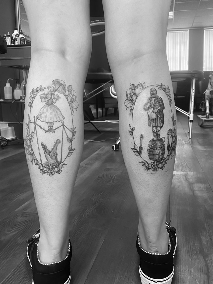Unique calf tattoos featuring detailed designs with floral accents on the back of legs in a tattoo studio setting.