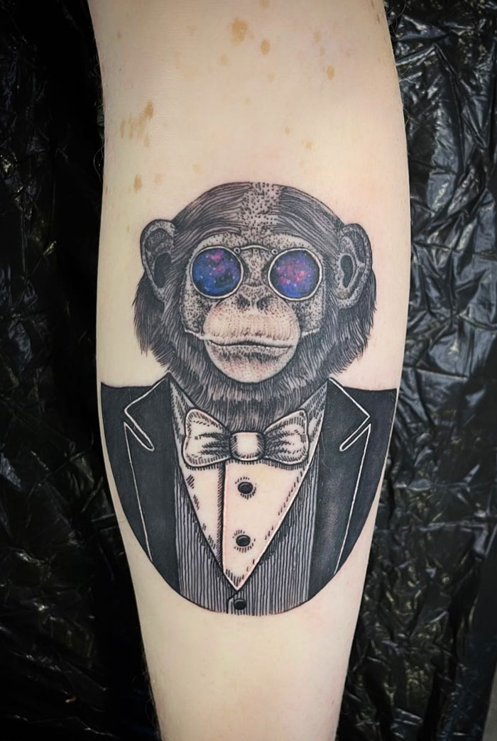 Chimpanzee with glasses calf tattoo