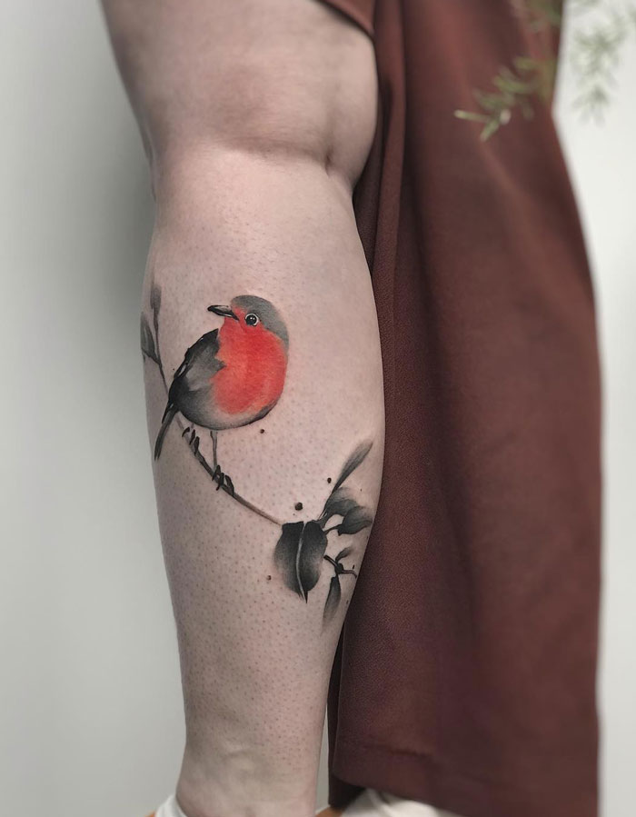 Watercolor bird calf tattoo