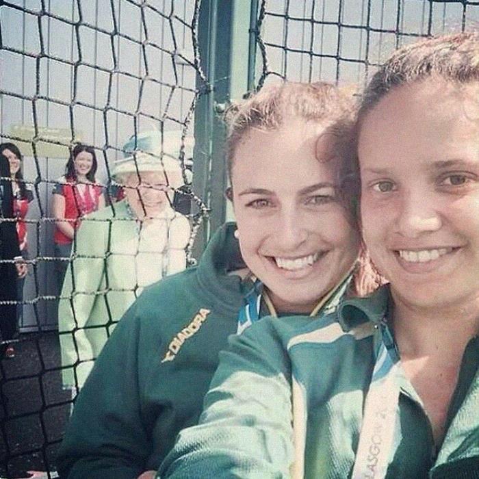 Totally Loving That The Queen Of England Photo Bombed This Pic Of Two Girls From The Aussie's Hockey Team In The Common Wealth Games