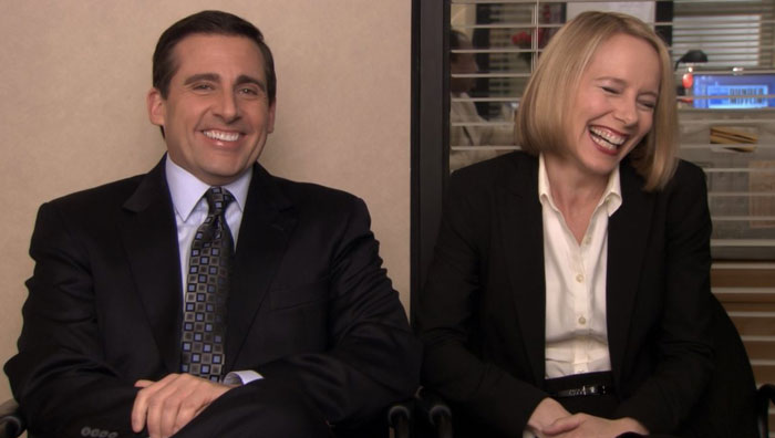 Michael Scott and Angela sitting and laughing