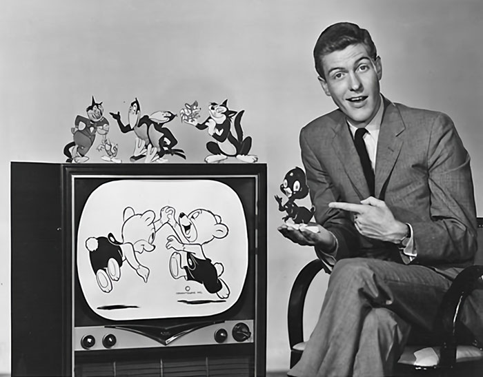 Person sitting with CBS cartoon characters and TV