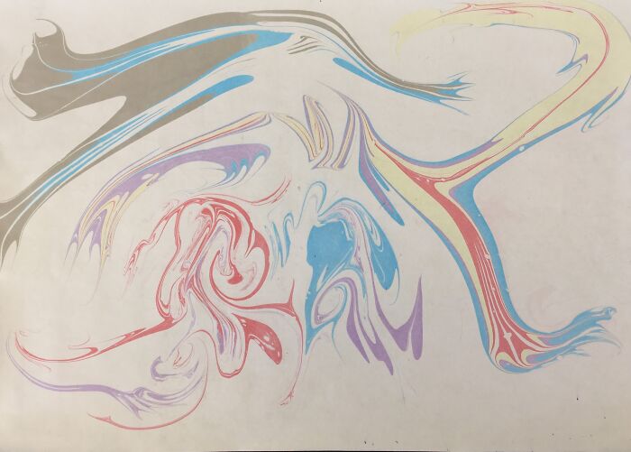 Traditional marbling art with vibrant swirling colors, resembling flowing tattoo designs.