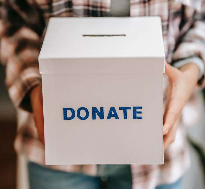 Person Holding Donation Box 