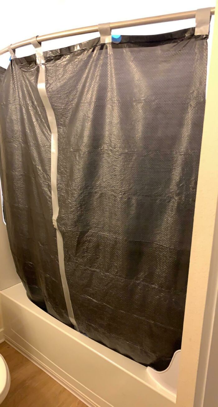 Olvidé comprar una cortina de ducha para el nuevo apartamento y no puedo conseguir una hasta mañana por la tarde. Dos bolsas de basura cortadas y un montón de cinta adhesiva