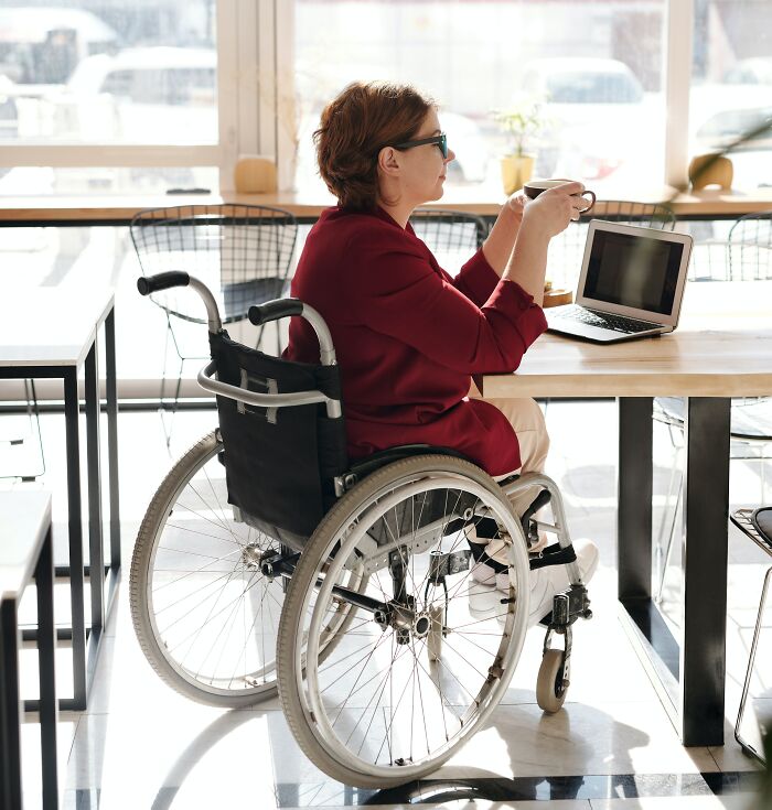 Woman In The Wheelchair Drinking Coffee 