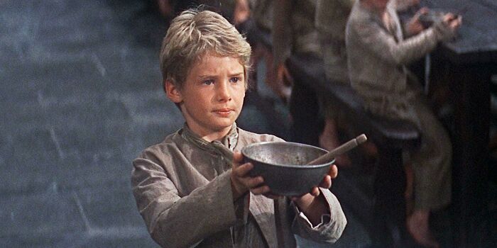 In “Oliver!” (1968), The Desperation Of The Orphans’ Hunger Is Demonstrated In This Scene Where Oliver Twist Asks For A Second Serving Of British Food, Which Is Something That No One Would Ever Do Unless On The Brink Of Starvation