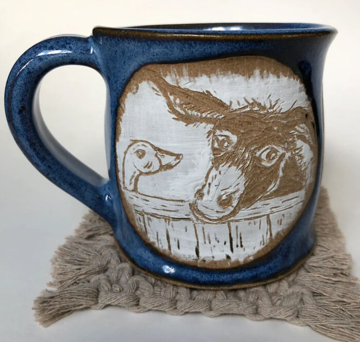 A Donkey Eyes The Exit, Not Too Sure Of Its Surprise Visitor