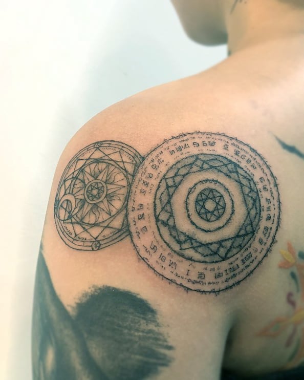 Intricate tattoo design on shoulder, inspired by Marvel superheroes, featuring circular geometric patterns.