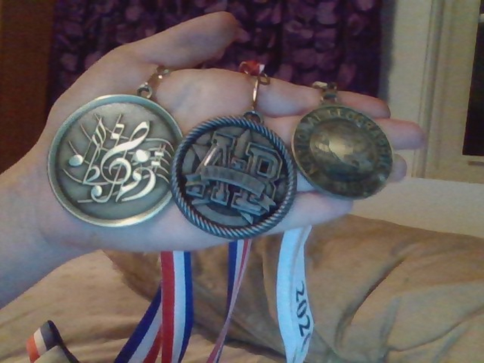My Medals! Left I Got At One Of The Competitions Last Year Because My Section Was Extra Awesome, Middle My School Gave Me For Half Of My Grades Being As And Bs Last Year And The Right One I Got When I Won My Schools Geography Bee (First Place!) I Was Supposed To Advance To The Town Wide One, But Covid Happened :/