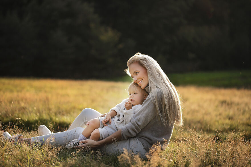 Photograph of a mom with her child in a field