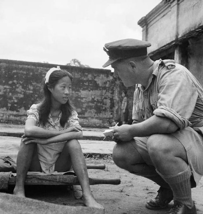A Young Chinese Woman From One Of The Imperial Japanese Army's "Comfort Battalions" Is Interviewed By A British Royal Air Force Officer In Rangoon After Being Liberated In August 1945