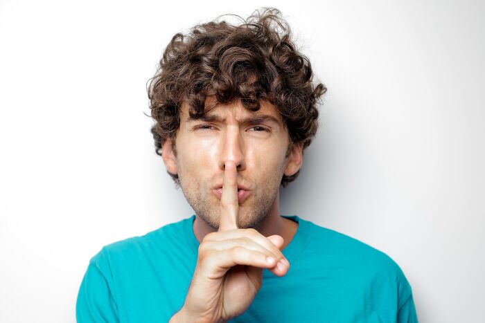 Man Holding His Finger To His Mouth 