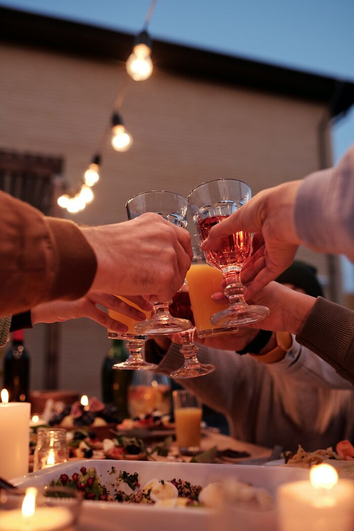 People Cheering On The Dinner Table 