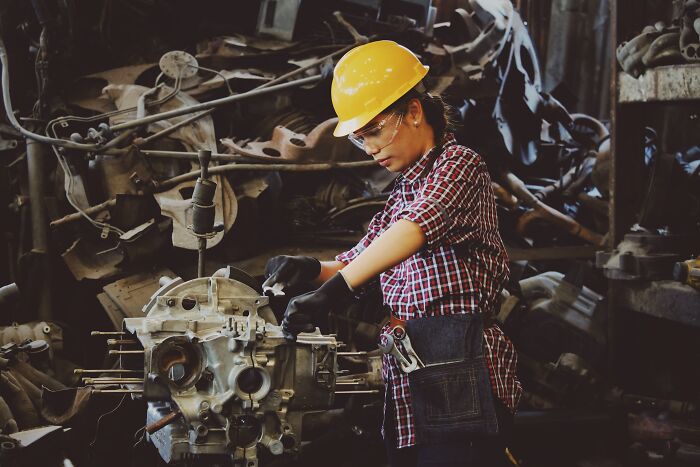 Woman Doing Heavy Duty Job With A Helmet And Safety Glasses 