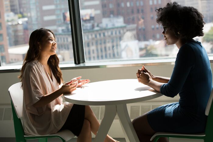 Two Girls Talking Inside On A Sunny Day 