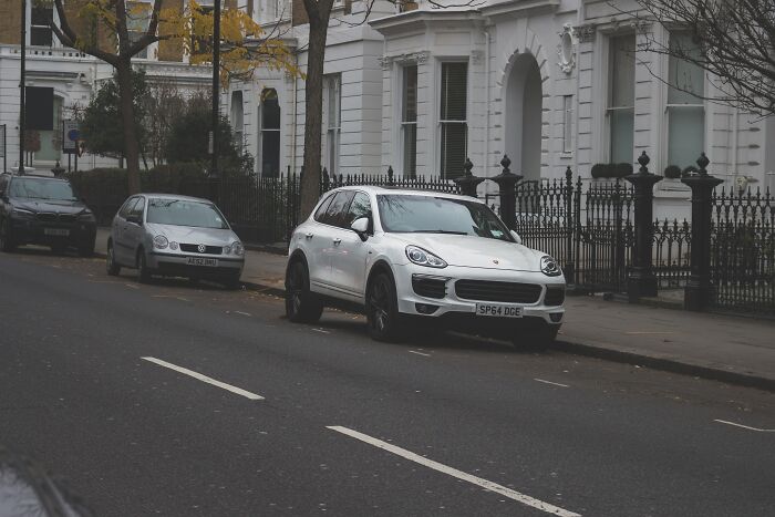 Cars Parked Near The House On The Road 