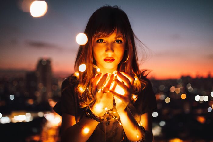 Woman Holding LED Lights In An Evening 