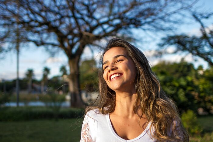 Woman Smiling And Looking To The Sun 