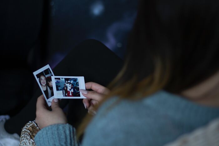 Woman Holding Polaroid Photos In Her Hands 