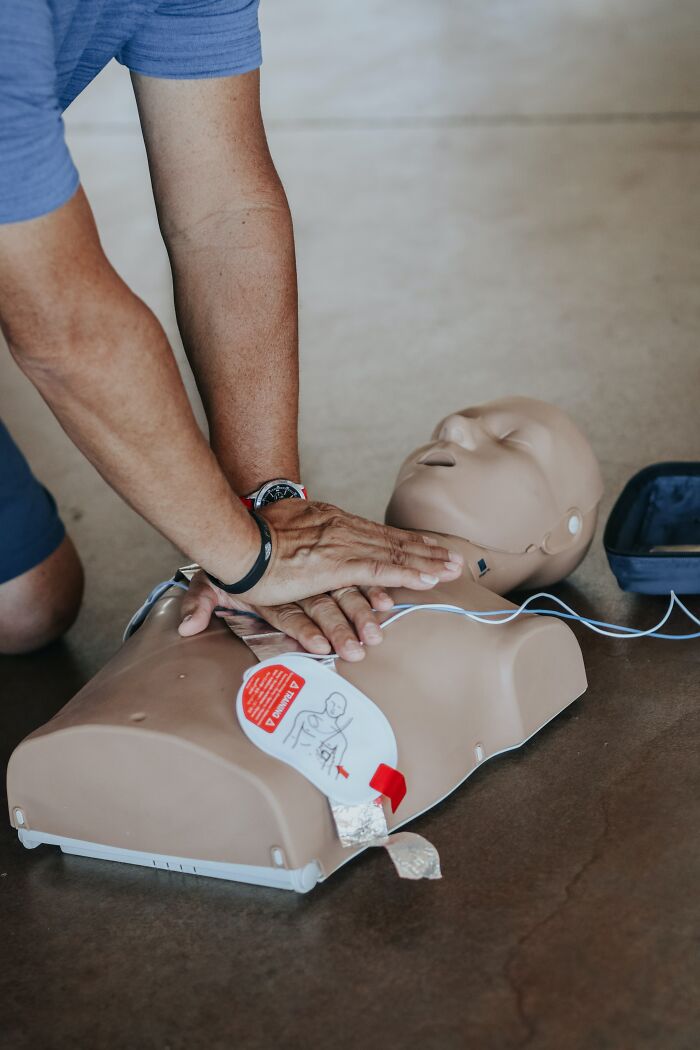 Man Doing CPR To A Mannequin 