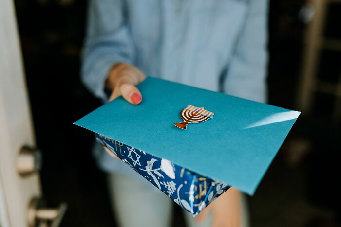 Woman Handing Gifts And A Letter To Someone 