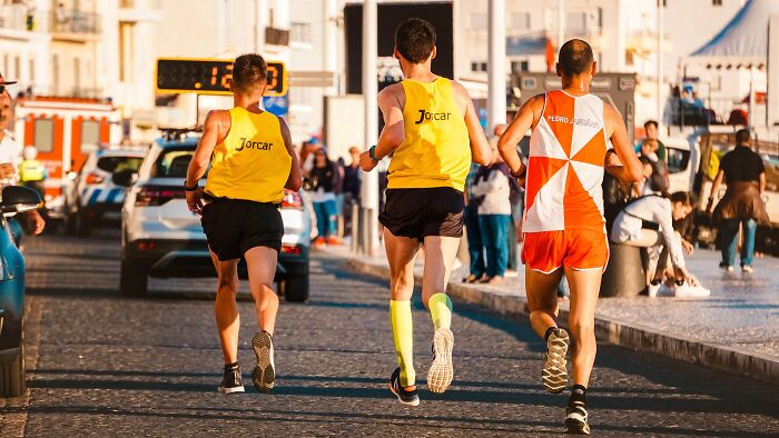 Three People Running A Marathon 
