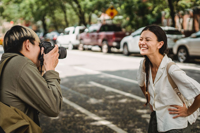 Person taking a picture of smiling woman