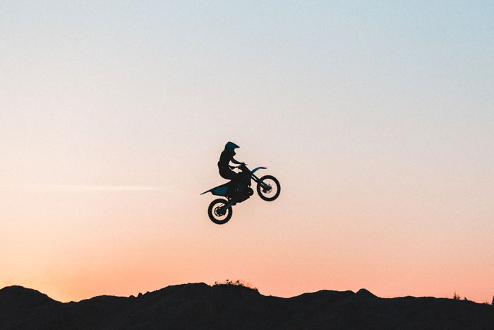 Man jumping with motorbike