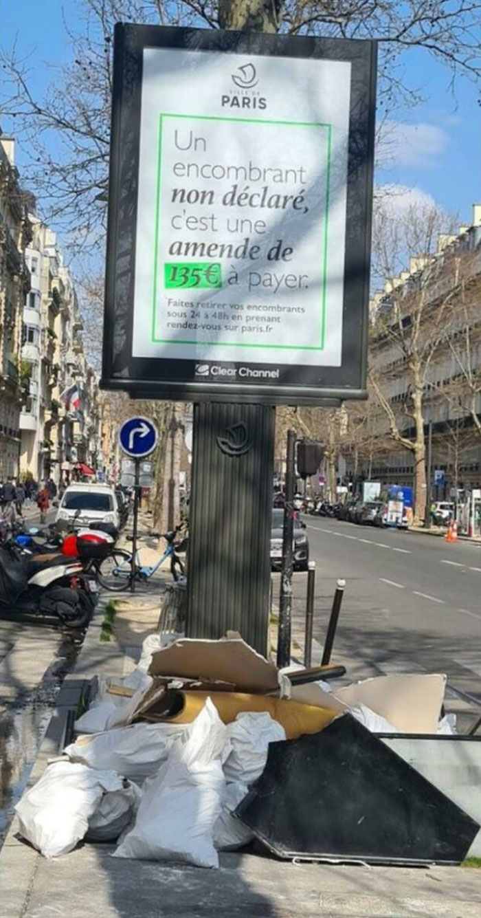 El letrero dice "Tirar basura ilegalmente en la vía pública se castiga con una multa de 135 euros"