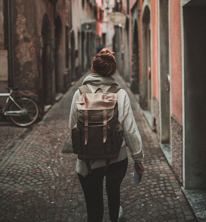 Picture of woman walking with travel backpack