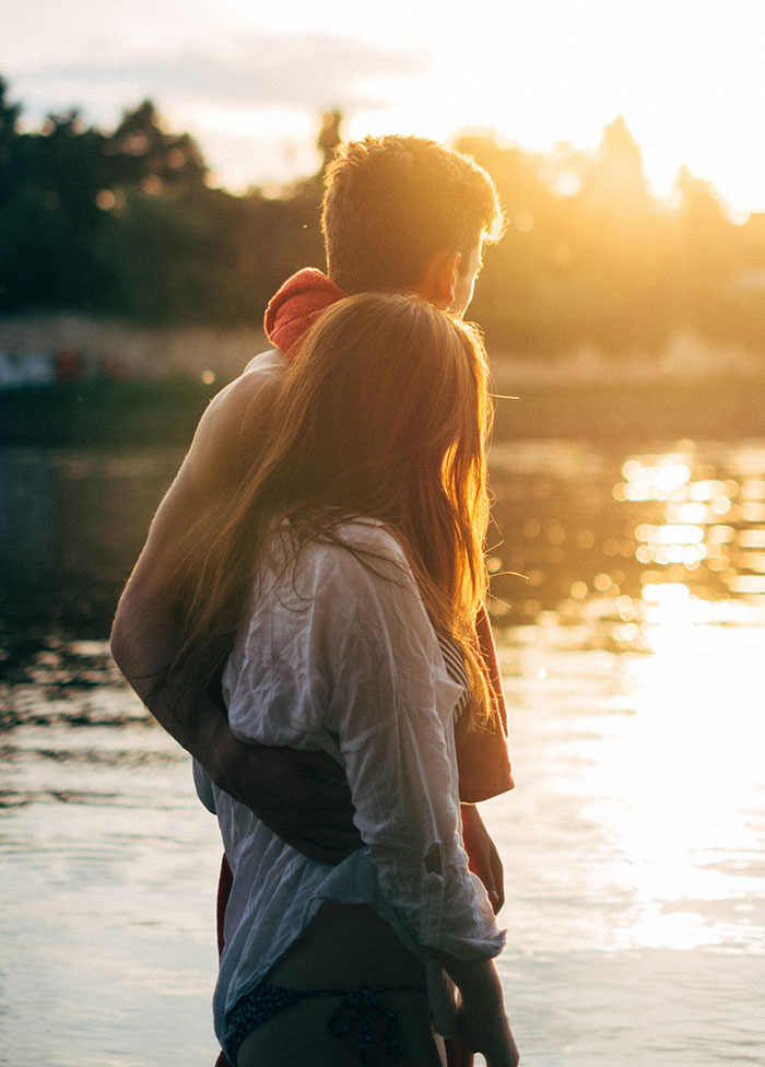 Persons standing and hugging