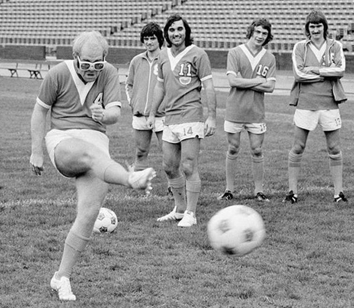 Elton John, Then Owner Of The Nasl’s Los Angeles Aztecs, Takes A Graceful Swing In Front Of George Best