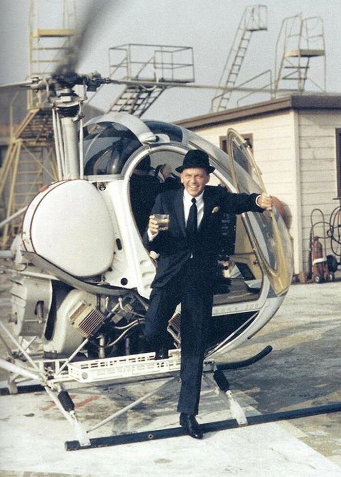 Frank Sinatra Getting Out Of A Helicopter With A Drink In His Hand