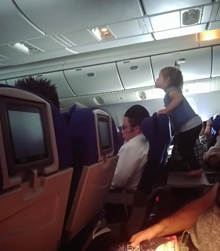 Parents Who Let Their Child Jump All Over Tray Table During An 8-Hour Flight Receive Online Backlash
