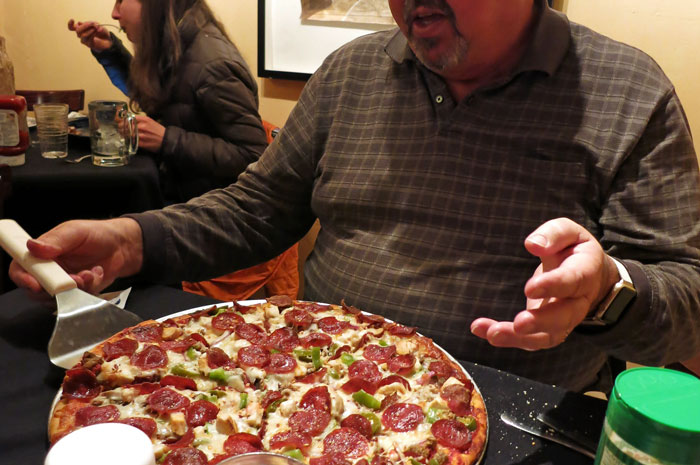 Pizza Maker Tries To Explain To Couple That They Ordered Too Many Toppings And The Pizza Won’t Cook, They Insist And The Worker Maliciously Complies