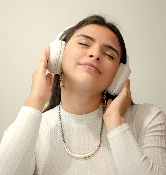 Woman wearing big white headphones 