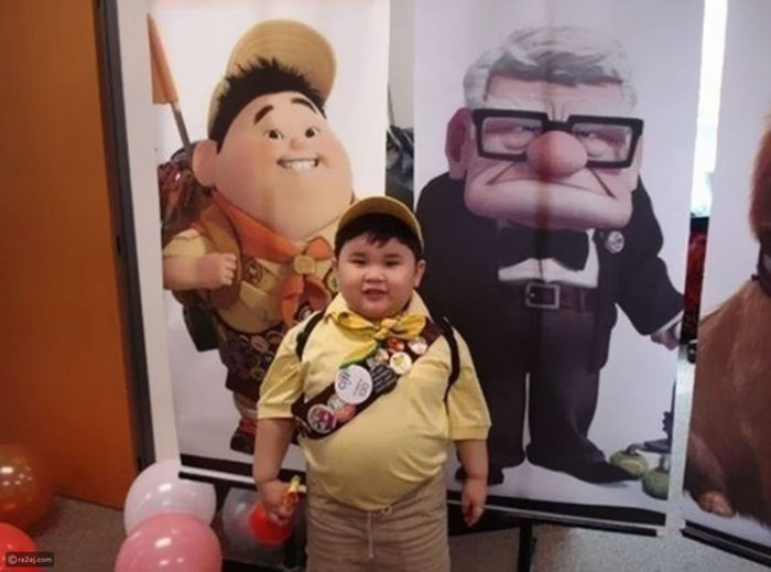 Scout boy posing in front of the Up poster 
