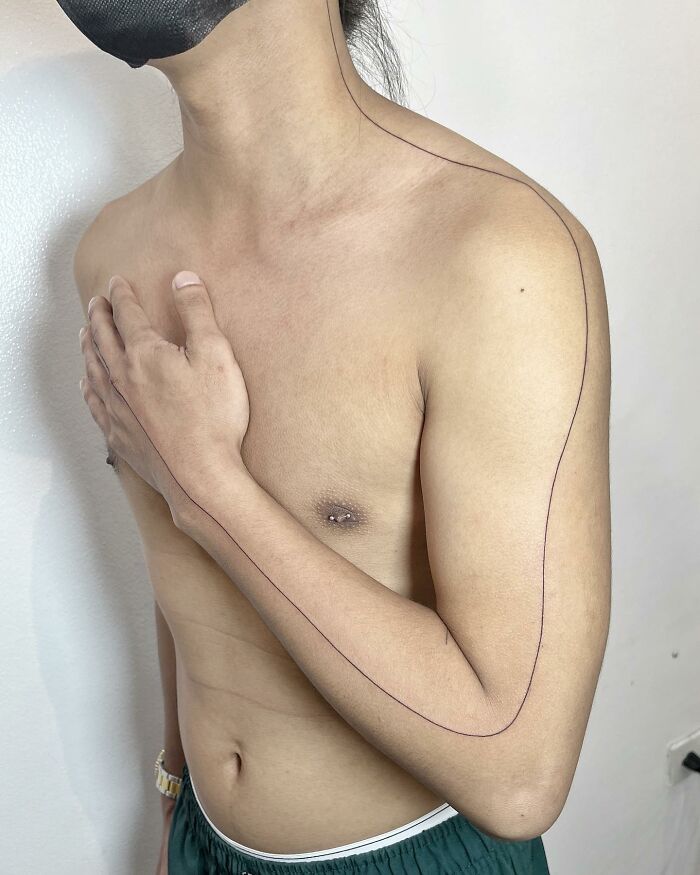 minimalistic tattoo of a seamline from neck to palms