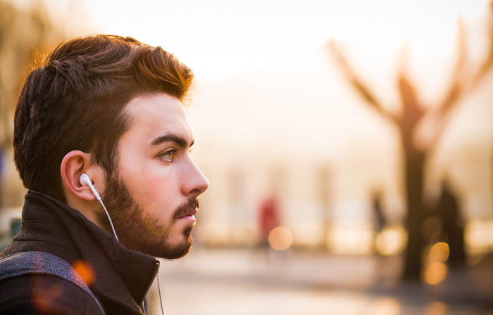 Man with white headphones listening to the music 