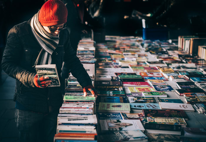 A man checking the books on market 