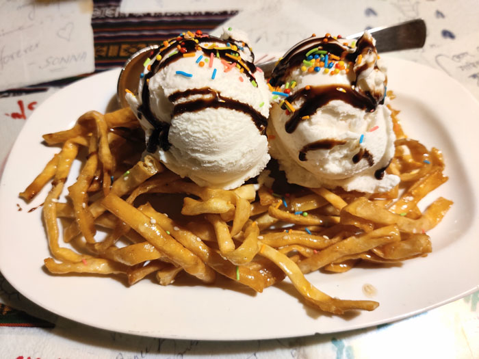 French fries with two ice creams balls on the top of it 